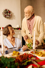 A senior couple shares a delightful Christmas meal, filled with smiles and love in their cozy home.