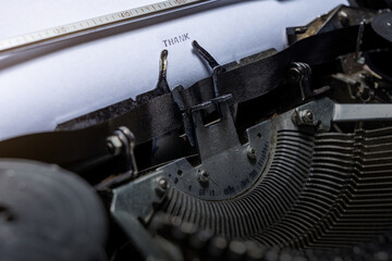 Fototapeta premium A typewriter and the word THANK written on the paper