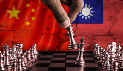 China vs Taiwan flag concept on chessboard. Political tension between China and Taiwan on pieces of...