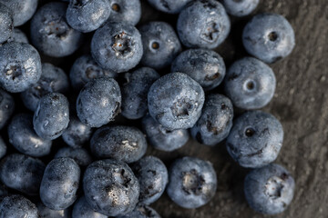 a pile of blueberries scattered on the board