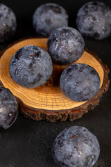 close-up of purple plum fruits in drops of water