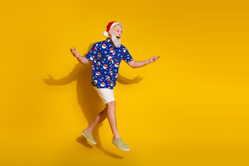 Full size photo of stylish modern santa jump look empty space wear x-mas winter print shirt isolated on yellow color background