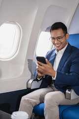 Successful business man, Airplane, travel, enjoying comfortable flight while sitting in the airplane cabin.