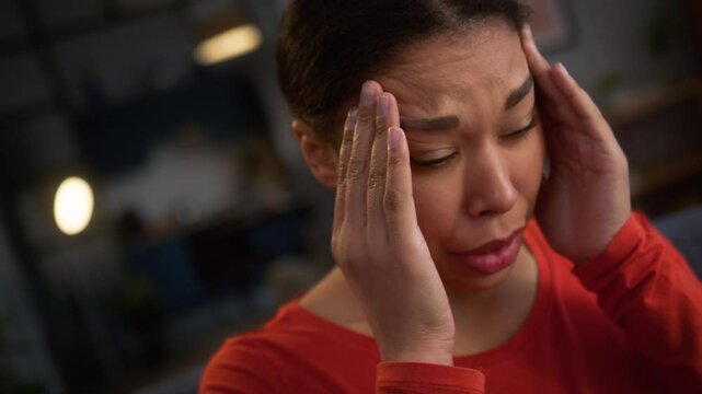 Close up African American woman female girl lady sad upset frustrated worried suffering headache feel head pain ache migraine ill sick medicine problem health trouble painful panic attack at home