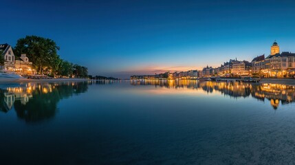 Obraz premium Nighttime cityscape with water reflection