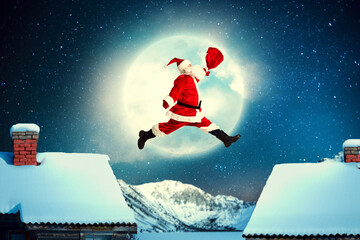 Fototapeta premium Santa Claus jumping between the roofs with a sack of gifts.