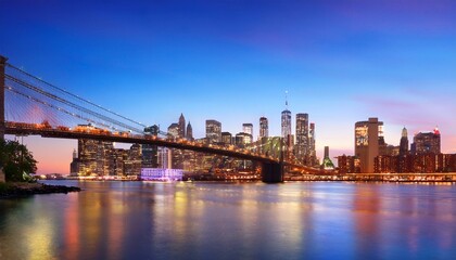 Fototapeta premium Brooklyn Bridge and Manhattan skyline during twilight, city lights reflecting on water, concept of urban landscapes