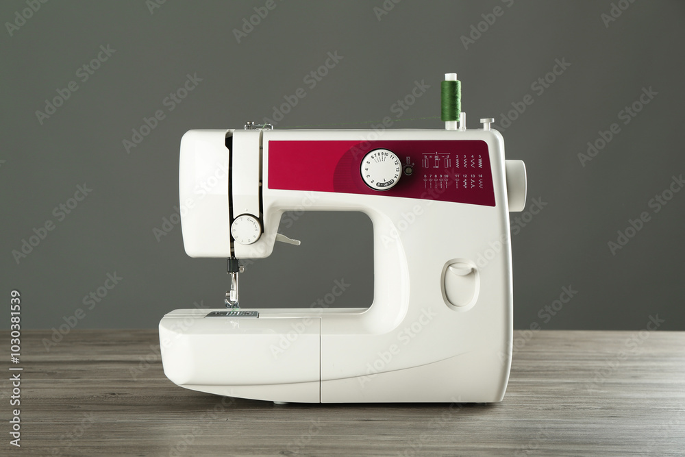 Canvas Prints One sewing machine on wooden table against grey background