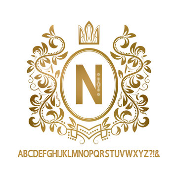 Golden vintage monogram and set of decorative capital letters. Gold N letter framed by wreath with crown.