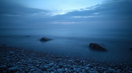 Calm Seascape with Rocks and Pebbles at Dusk