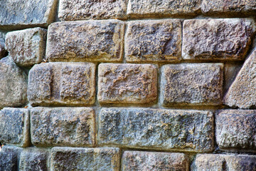 Rectangular stone wall background in gray on a clear sunny day, texture backgrounds for graphic design. The wallpaper is abstract.