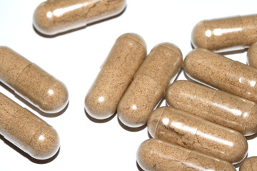 Vitamin Capsules and Pills on a White Background For Medication round and long shaped