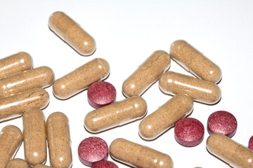 Vitamin Capsules and Pills on a White Background For Medication round and long shaped