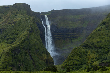 Breathtaking view of waterfall in the green mountains on Flores island Azores Portugal