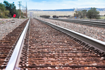Fototapeta premium American railway with oak cross beams against a stone gravel (USA)