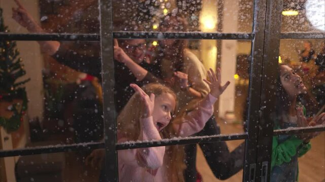 Parents and a teen girl on Christmas night with the first snowfall