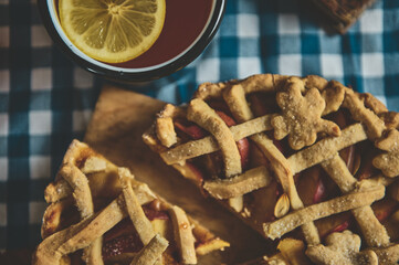 Close-up of a homemade apple pie with intricate lattice crust design on a wooden board 