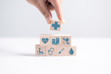 Concept of health insurance is represented by wooden cube, symbolizing comprehensive plan includes...