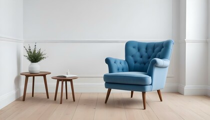 A tufted blue armchair in a minimalist room with white walls and a wooden floor.