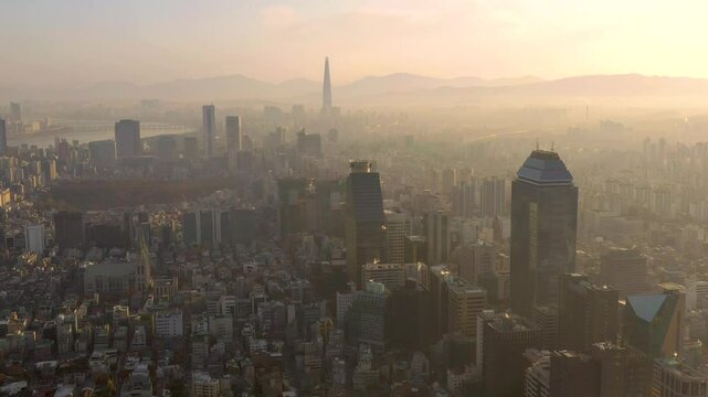 SEOUL, SOUTH KOREA - SEPTEMBER 9, 2024: Aerial view of the city skyline shrouded in mist at dawn with tall buildings