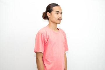 Fototapeta premium An Indonesian, Asian man wearing a pink tshirt formal style involving his partner with standing confidence like a mature person and a young businessman. isolated in white background