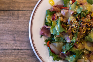 salad of fresh vegetables, greens and beef with sauce