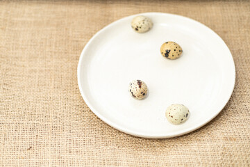 quail eggs on a plate, four quail eggs