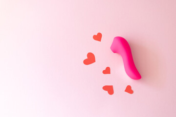 pink vibrating sex toy with hearts a pink background