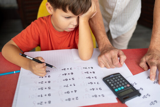 A six-year-old boy with dyscalculia and dysgraphia tries to complete his math homework.
