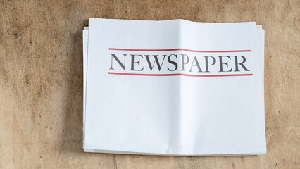 Newspaper on wooden background