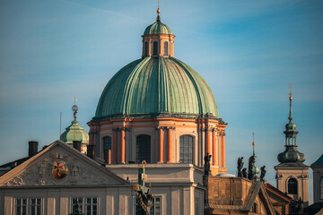 Exploring the stunning architecture of Prague with its iconic domed rooftops in the warm afternoon sunlight