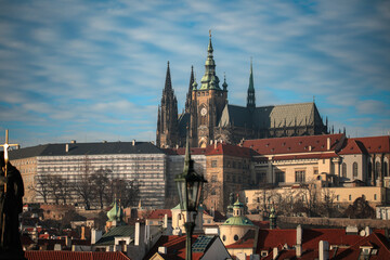 Naklejka premium View of Prague Castle with its iconic spires against a clear blue sky in the vibrant city of Prague, showcasing historical architecture