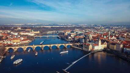 Aerial view of the Vltava River and historic architecture in Prague under a clear blue sky