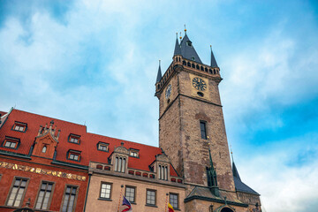 Fototapeta premium Historic clock tower in Prague under a bright blue sky during early morning hours