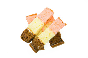 Pieces of layer cake arranged in a pile isolated on white background. Slice of layer cake