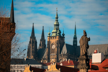 Obraz premium View of Prague Castle with Gothic spires under a bright blue sky during the day in the historic city of Prague Czech Republic