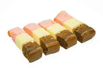 Layer cake pieces are arranged in a row isolated on white background. Slice of layer cake