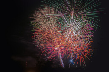 Fototapeta premium green ehite and red Fireworks On The Background Of The Dark Night Sky in Dalmine (BG),Italy, show for New Year's eve