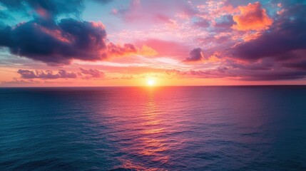 Fototapeta premium Aerial view of Epic Sunset over the Ocean and Sky with Clouds on the Horizon 