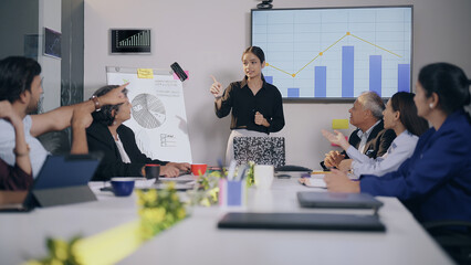 Indian Asian man expert woman lady team leader show growth chart idea talk discuss global index young adult girl male staff group use TV screen share graph data learn stock trade job office work place