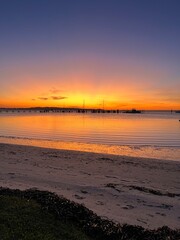 Vibrant sunset colors over harbor with docked boats