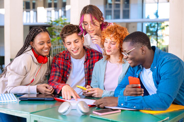 group of five happy students are studying outdoors at university, using smartphones. They're engaged, collaborating, and enjoying their learning experience in a modern, tech-friendly environment