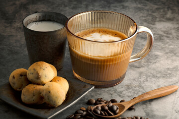 Hot latte, coffee beans and fresh milk with baked desserts
