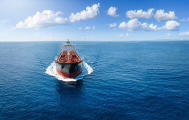 Aerial front view of a chemical goods or oil tanker sailing with speed over the ocean as a concept...