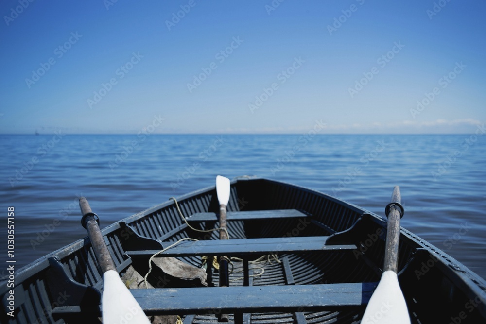 Wall mural serene seascape with a floating boat