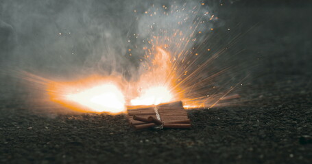 Firecrackers igniting and emitting smoke in slow-motion at 800 fps, capturing the intense burst of...