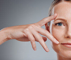 Beauty, hand and portrait of woman in studio on gray background for facial cosmetics. Half face,...
