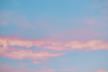 A beautiful sky tinted by the sun leaving vibrant shades of gold, pink, blue and multicolored. Clouds in the twilight evening and morning sky. Cloudy sky background in the evening, and during the day.