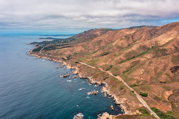 Obraz premium Highway 1 and Big Sur along the Pacific Ocean coast, beautiful landscape and aerial view, sunset, sunrise, fog. Concept, travel, vacation, weekend