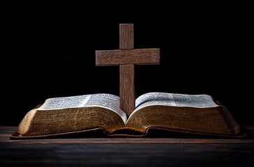 A wooden cross stands on an open Bible in a dimly lit room during evening hours
